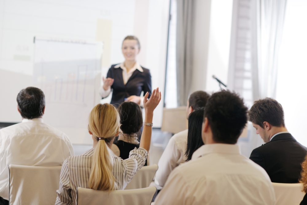 Woman presenting to business people