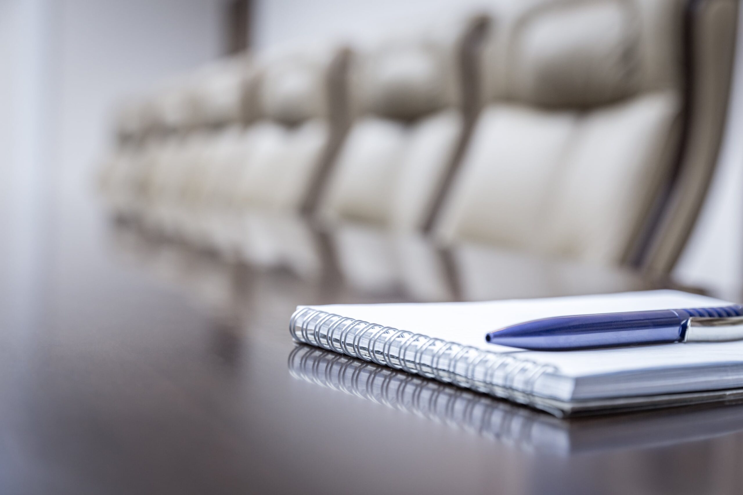 Boardroom with notepad and pen on the table ready for the presentation