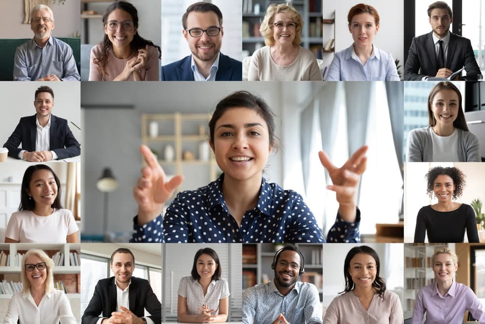 Lots of people smiling to demonstrate this essential body language when presenting online