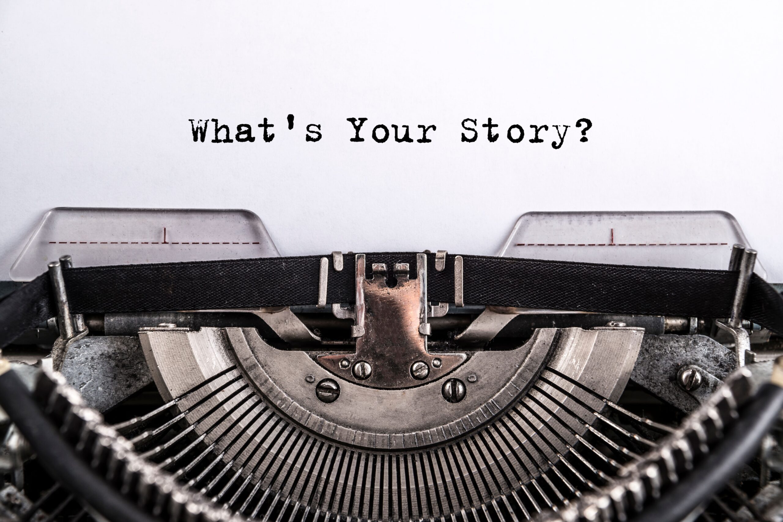 typewriter with words whats your story
