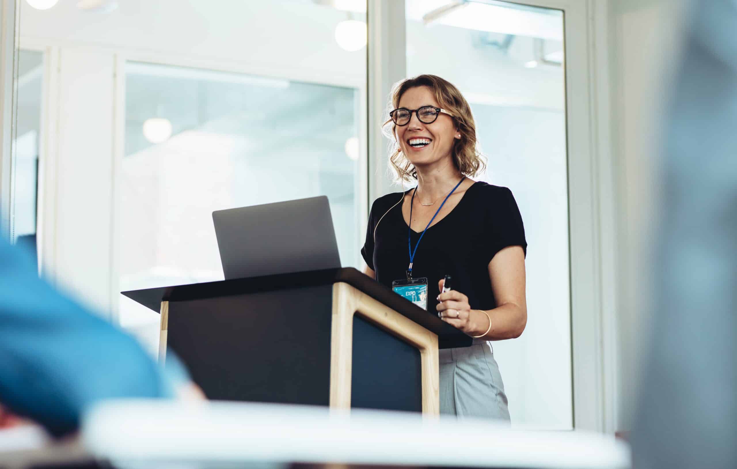 female presenter at lectern presenting at a conference for the first time