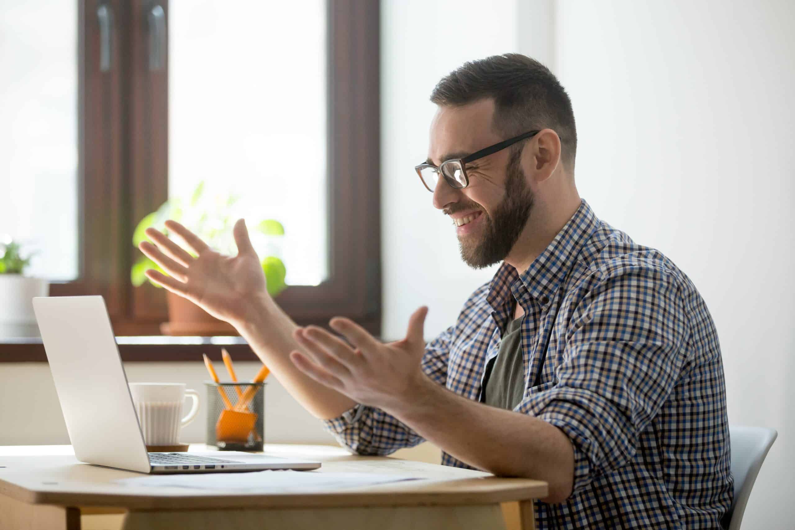 Man video-conferencing at laptop
