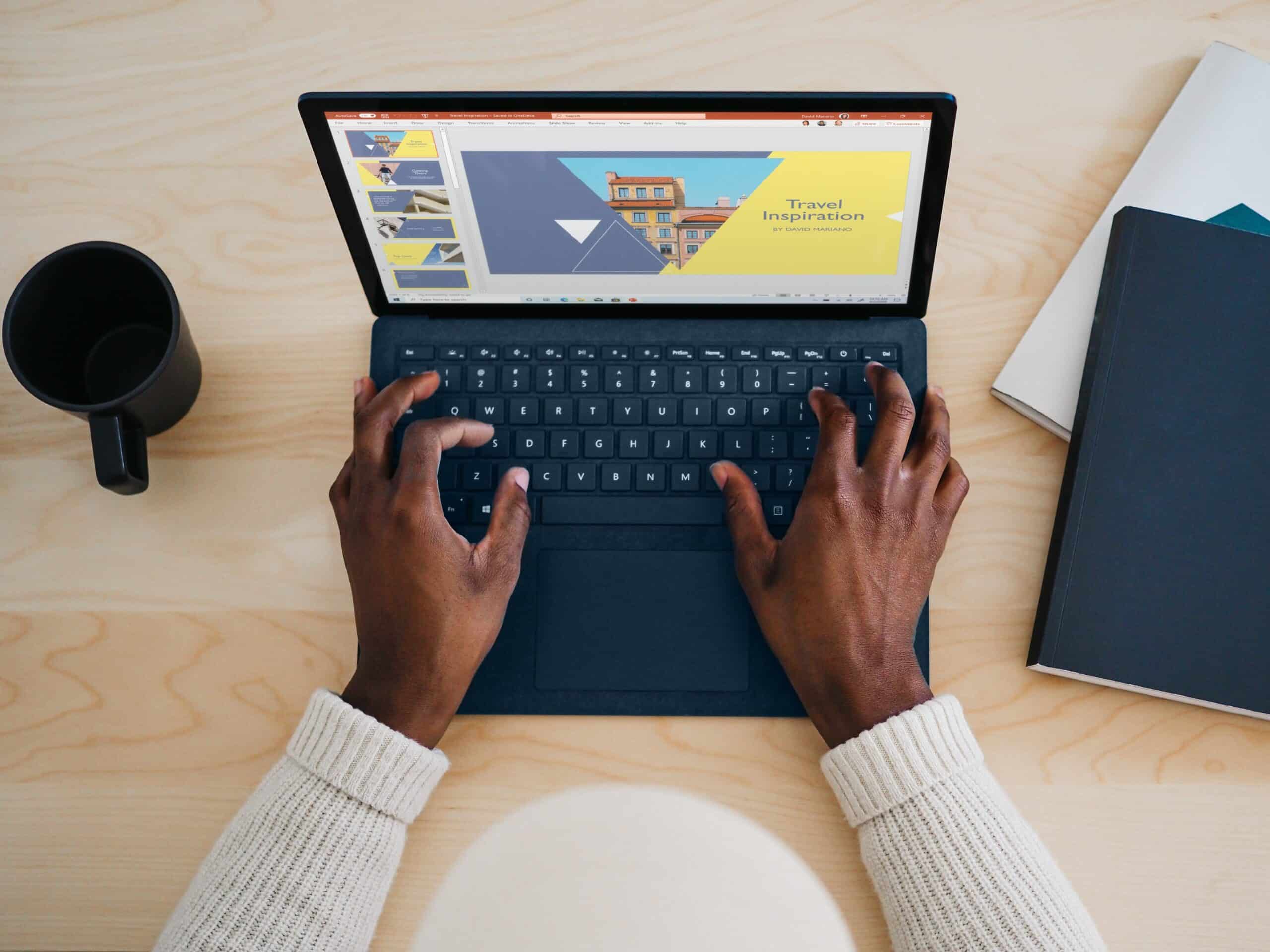 Man's hands on laptop watching webinar