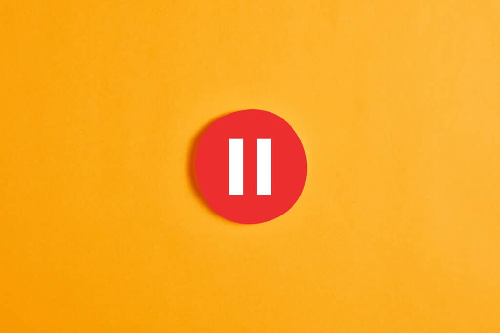 Red,Round,Circle,With,A,Pause,Button,Or,Icon,Against