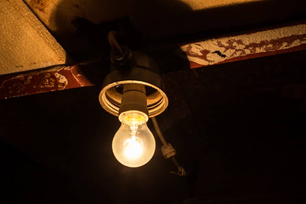 Light,Bulb,On,Ceiling,In,Old,Basement,Or,Garage,,Yellow